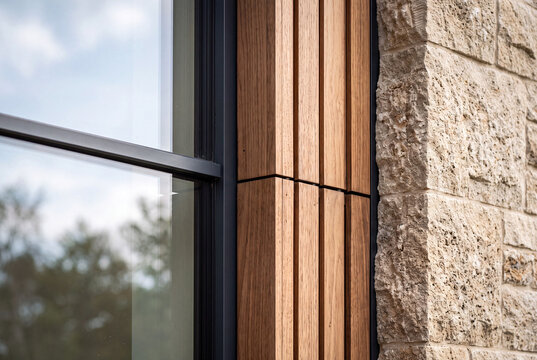 Modern Building Facade Detail with Natural Stone, Timber Cladding and Aluminum Window Frame