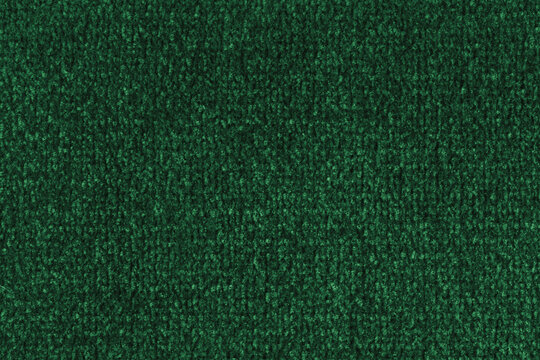 Close up, macro of green fabric texture with soft velvet, fluffy woven surface, microfiber textile detail. Knitted jersey cloth background, backdrop, wallpaper for design, fashion or interior