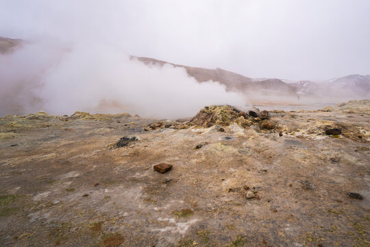Geothermal steam rising from volcanic landscape in Iceland