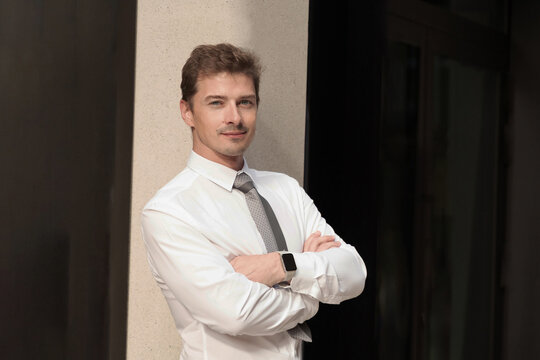 Confident young businessman in white shirt and tie