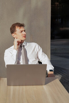 Young businessman work on laptop at outdoor table