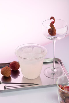 Lychee cocktail ingredients with glass and beverage preparation