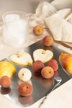Lychee cocktail ingredients with pear, ice and glass
