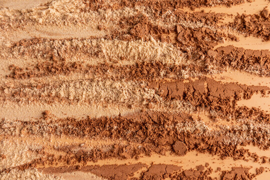 Brown cosmetic powder texture with abstract striped layout