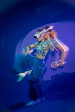 Young woman use virtual reality headset with motion blur