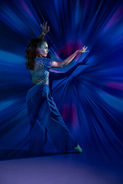 Young woman dance in abstract blue light