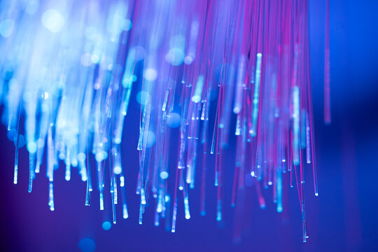 Fiber optic technology background with blue and purple light