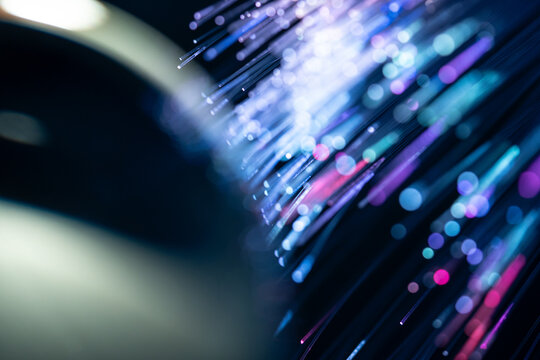 Fiber optics technology background with colorful light trails