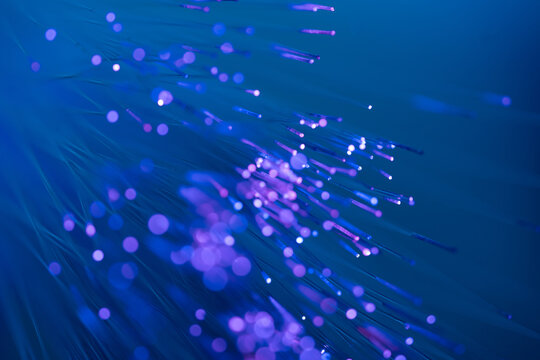Fiber optic technology background with violet light trails