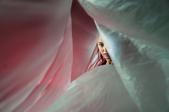 Latin woman dancer framed by flowing translucent fabric