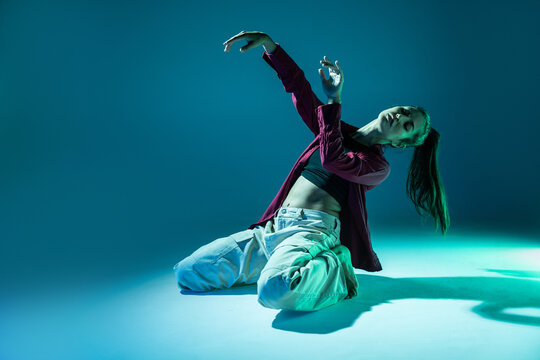 Latin woman dancer perform expressive contemporary dance pose
