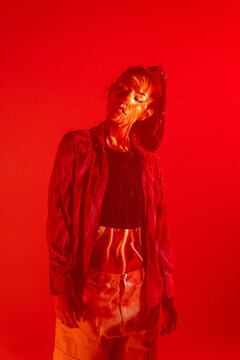 Latin woman dancer in red light with patterned shadow