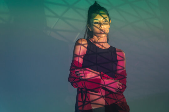 Latin woman dancer with geometric light projection