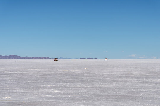 Vehicles cross Salar de Uyuni salt flat in Bolivia