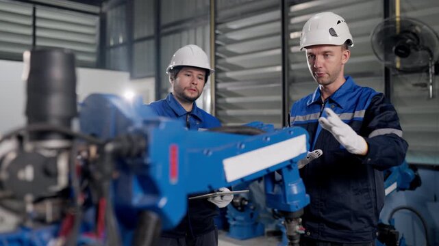 Robotics service team inspect industrial welding robot arms before delivery, ensuring welding robot for production readiness, reliability, precision, factory automation.