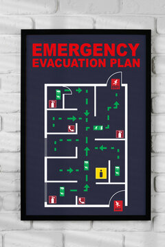 Emergency evacuation plan displayed on a wall showing exit routes and safety information