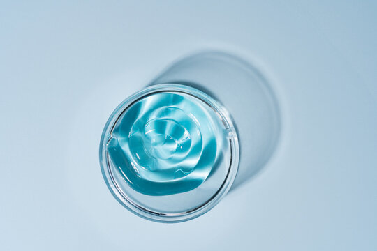 Blue cosmetic gel texture in transparent glass container