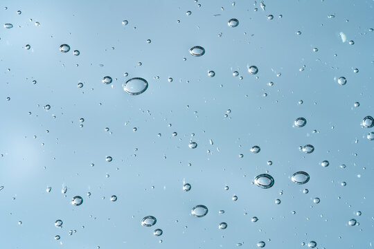 Clear cosmetic gel texture with water droplets background