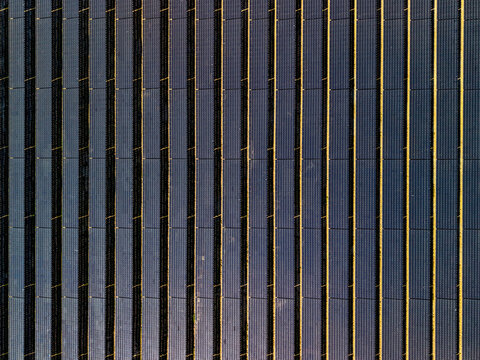 Aerial view of the Sun Metals Corporation solar farm featuring rows of photovoltaic panels arranged in a geometric pattern in Stuart, Queensland, Australia.