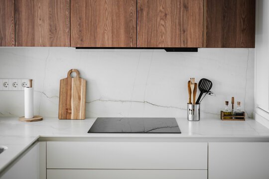 Modern apartment kitchen with wood cabinet and marble countertop