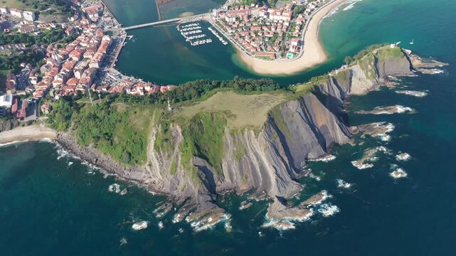 Aerial Panoramic View of Sunrise Over the Coastal Town of Ribadesella, Santa Marina Beach, Sella River Estuary, and Coastal Cliffs in Asturias, Northern Spain