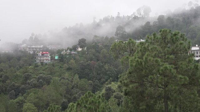 Low monsoon clouds over forested hills in Kausani, Uttarakhand, India