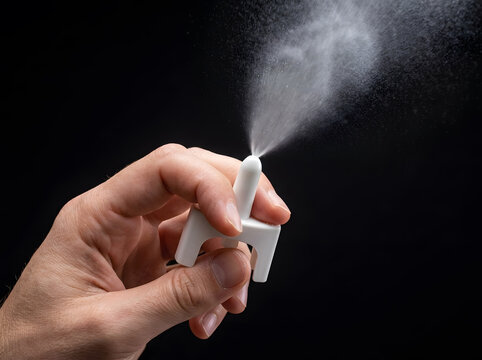 Nasal Spray Dispersion Spray Mist Close Up | Hand Pressing Nasal Spray Bottle with Atomized Mist | Medical Spray Bottle Dispersing Fine Liquid Mist | Nasal Decongestant Spray Atomizer Spray Effect