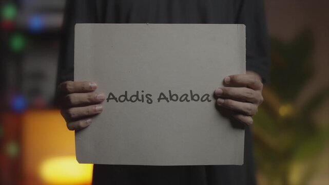Addis Ababa Written on Banner &ndash; Man Holding Placard