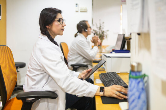 Female doctor use computer at medical clinic reception