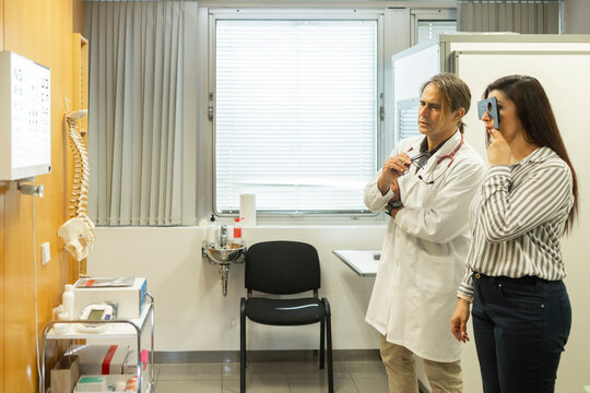 Doctor and patient review eye chart in medical clinic