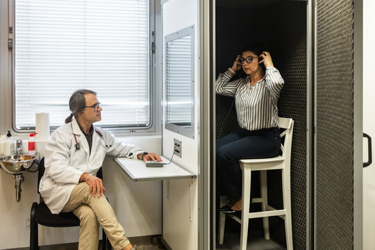 Doctor conducts hearing test for patient in medical clinic