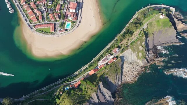 Aerial Panoramic View of Sunrise Over the Coastal Town of Ribadesella, Santa Marina Beach, Sella River Estuary, and Coastal Cliffs in Asturias, Northern Spain