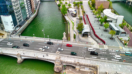 Naklejka premium Aerial view of Osaka bridge and river with urban skyline and cityscape