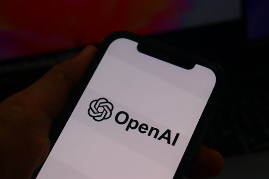 OpenAI logo on smartphone screen held in hand, artificial intelligence mobile app interface, digital technology and machine learning concept