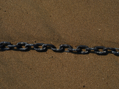 Old anchor chain on a boat by the beach