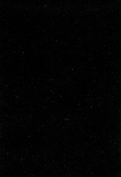 Authentic film grain and dust overlay on black background for retro photography and cinematic video projects featuring fine scratches and organic speckles for professional results.