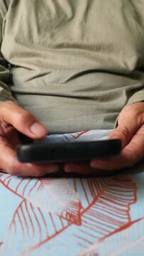 Close up of a person holding a smartphone and using it.