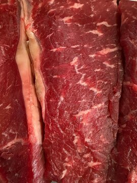 Raw beef steaks with rich marbling, showcasing fresh red meat texture and protein, ready for cooking and culinary preparation
