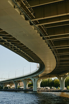 Vertical image of modern concrete highway bridge over river, showcasing urban infrastructure and civil engineering, suitable for construction and city planning marketing