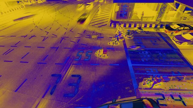 traffic in central bangkok with code and data overlayed in the buildings 