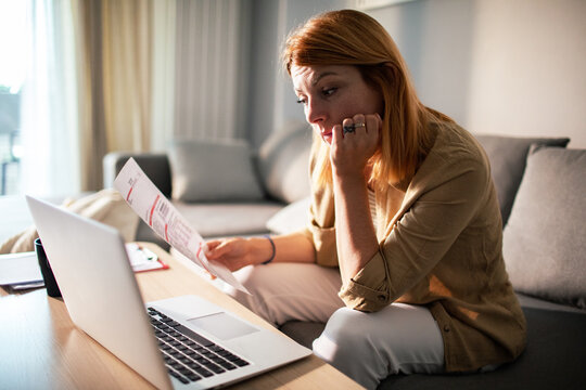 Worried woman reviewing utility bill at home