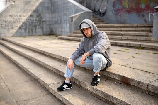 Breakdancer performing low ground move on concrete steps