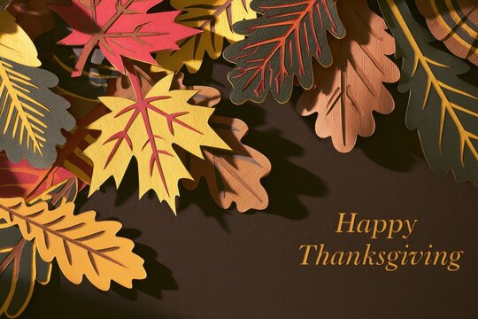 Modern Paper Cut Autumn Leaves Frame with Happy Thanksgiving Typography on Elegant Brown Background