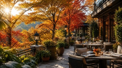 Obraz premium Elegant outdoor restaurant terrace surrounded by vibrant autumn foliage offering scenic dining experience at sunset