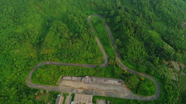 Aerial view of Kalan Circuit surrounded by lush tropical forest and hills in Samarinda, East Kalimantan, Indonesia.