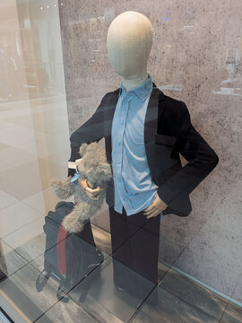 Stylishly Dressed Mannequin Carrying Luggage and Toy