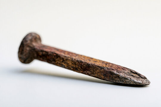 Single rusted railroad spike macro railway heritage industrial detail