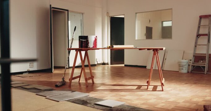 Interior, empty room and renovation supplies for construction, upgrade and office improvement. Commercial, building and hardwood flooring with paint, workspace design and remodeling for refurbishment