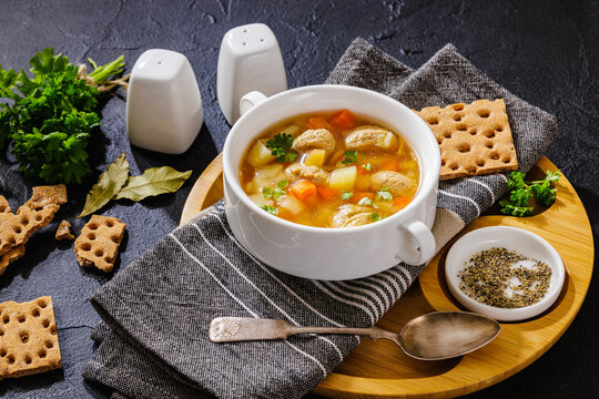 Austrian meatball soup with veggies in a bowl