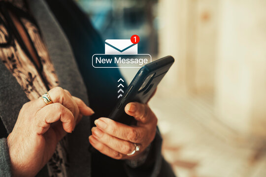 Mature woman checking smartphone notification with new message alert icon. Digital communication, technology in everyday life, and senior smartphone usage concept.